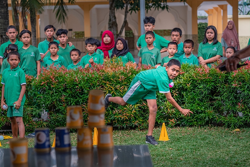Playing Tin Can Toss Game